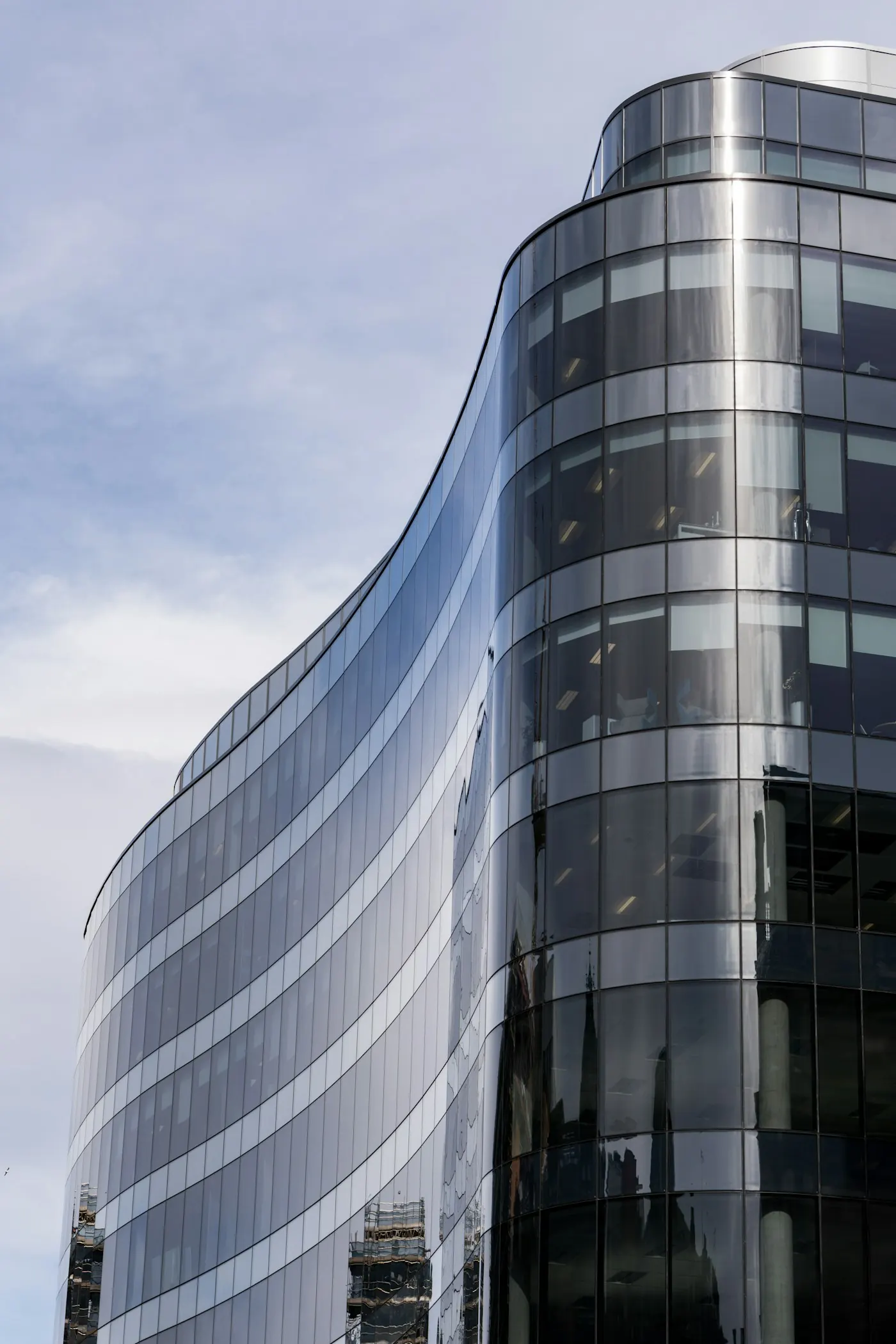 Curved glass office tower facade, an institutional-grade commercial real estate asset